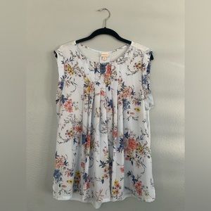 Sleeveless floral top with solid light blue back